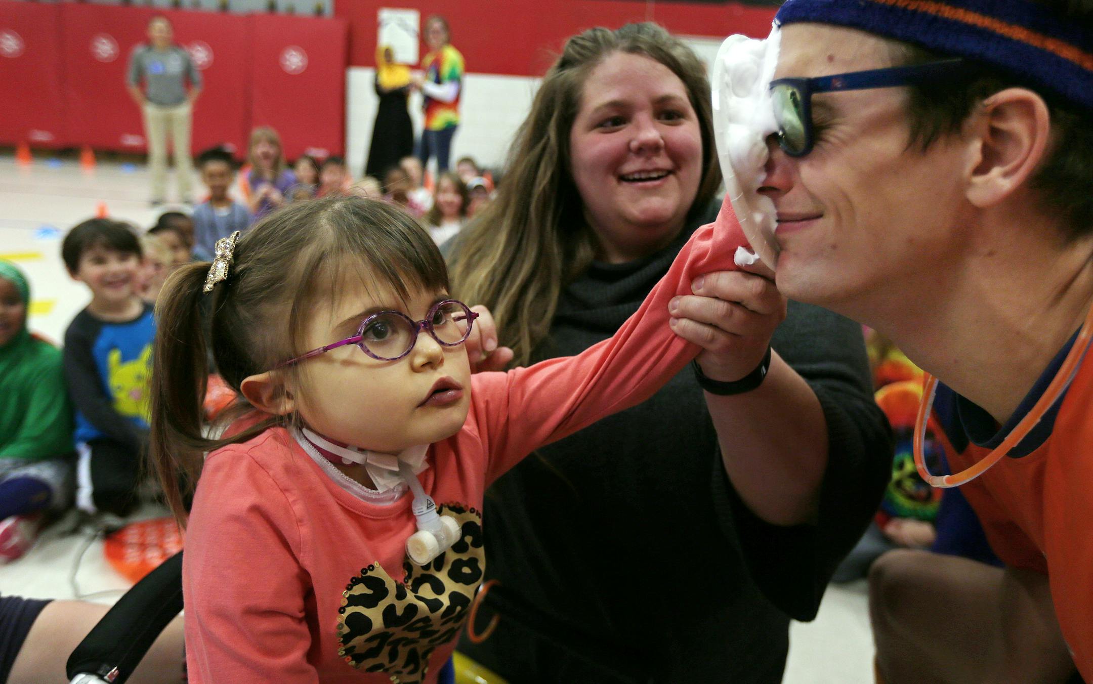 Cassandra Degerstrom helped Victoria Sardinha smash a pie in the face of Ryan World of Apex Fun Run. The fund raiser was held at Gideon Pond Elementary Monday November 30, 2015 in Burnsville MN.] The school is holding a fun run to raise money so kids like Victoria Sardinha can play on the school's playground. Lisa Sardinha (Victoria&#xed;s mom) and others are trying to raise the $80,000 it will take to build a handicapped accessible playground. Jerry Holt /Jerry.Holt@Startribune.com