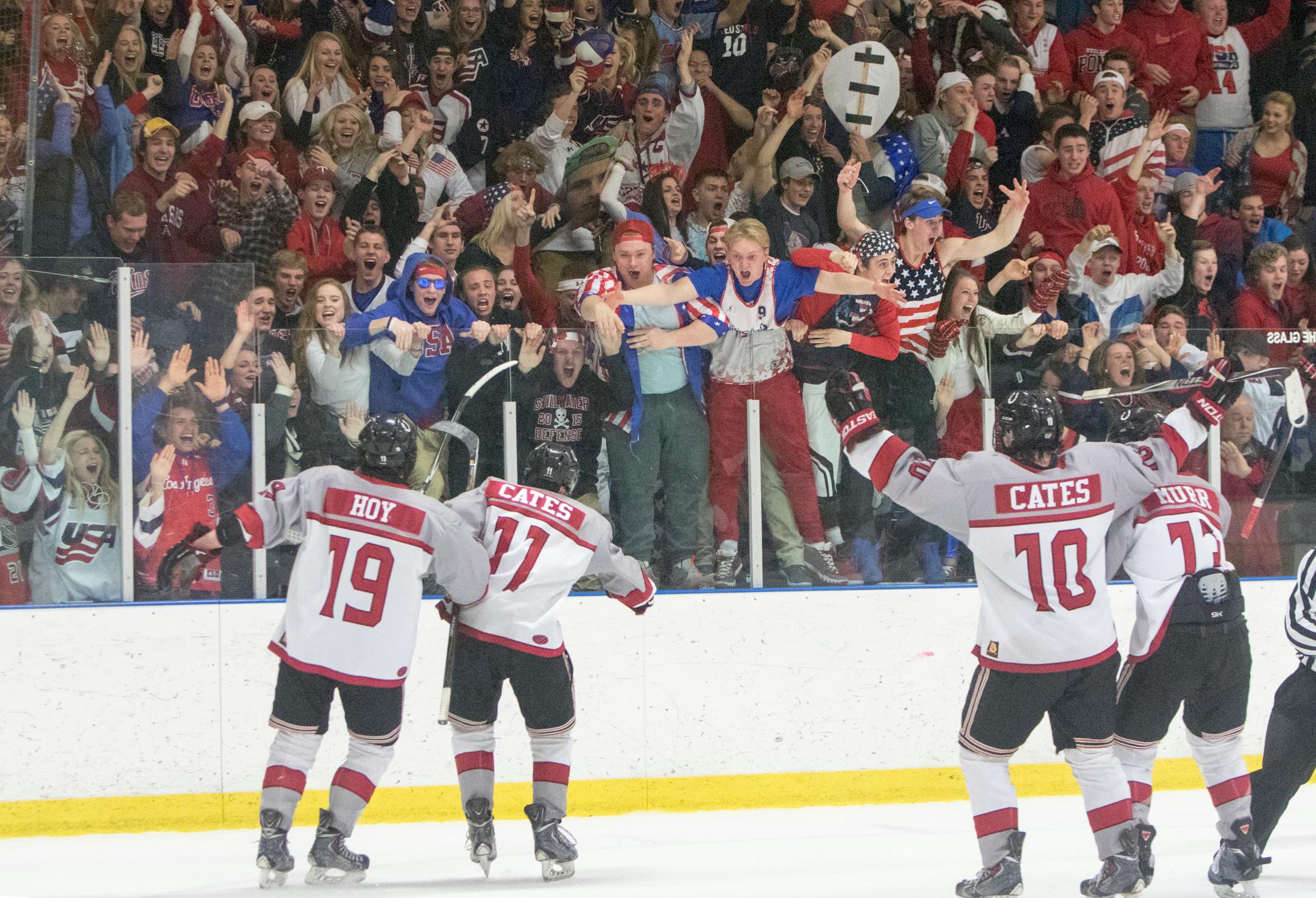 Stillwater defender Andrew Hoy (19), Stillwater forward Noah Cates (11), Stillwater forward Jackson Cates (10) and Stillwater defender Austin Murr (13) are the first to celebrate with fans after the overtime game winning goalin the 2016 MSHSL Boys Class 2A Section 4 finals on Feb. 26 at Aldrich Arena in Maplewood, Minn. ] Special to Star Tribune MATT BLEWETT � matt@mattebphoto.com - February 26, 2016, Woodbury, MN, Stillwater Ponies, Hill-Murray Pioneers, MSHSL Boys' Hockey, 686874 PREP022716