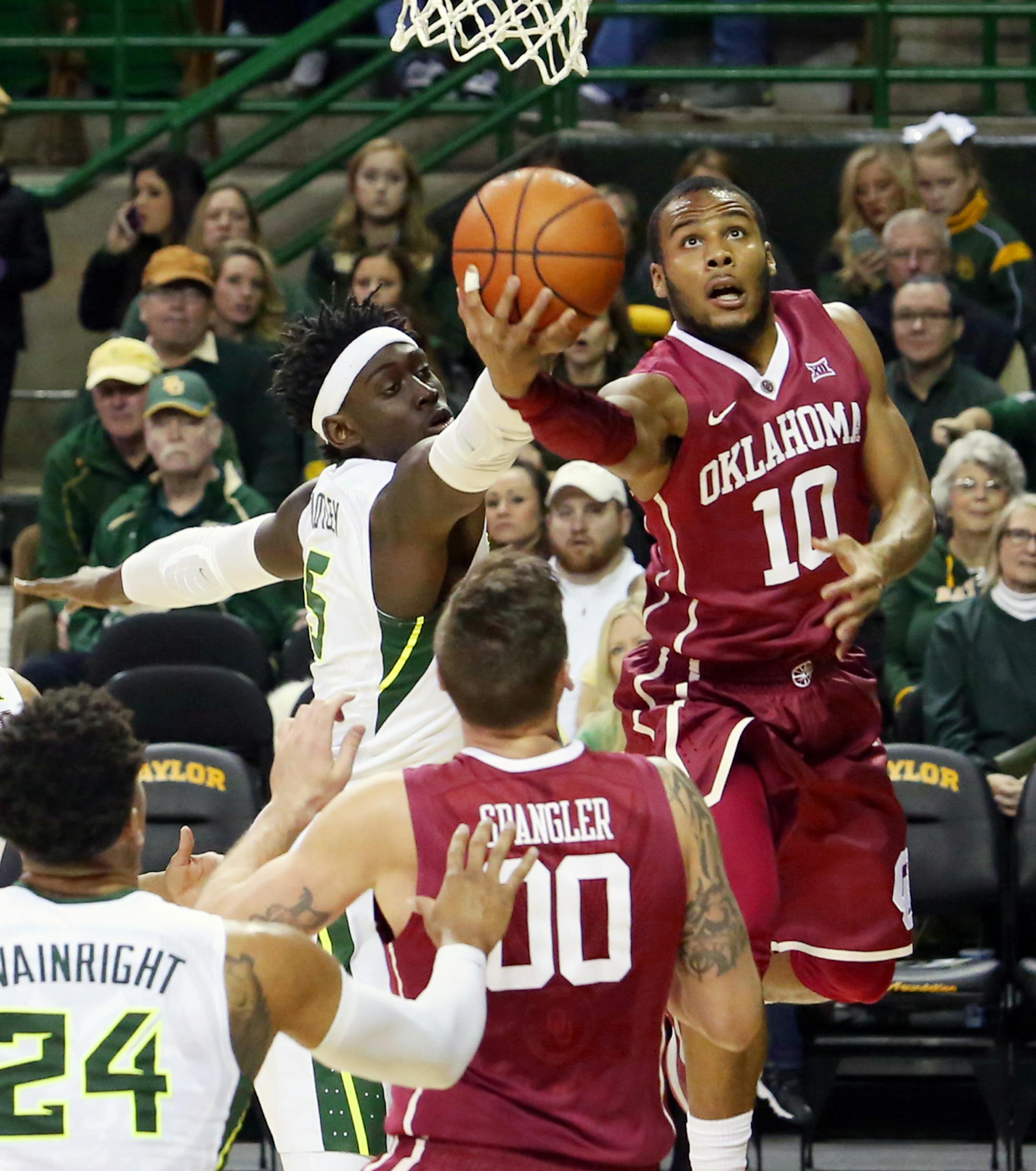 Oklahoma guard Jordan Woodard (10) scores past Baylor forward Johnathan Motley (5) in the first half of an NCAA college basketball game, Saturday, Jan. 23, 2016, in Waco, Texas. Oklahoma won 82-72. (AP Photo/Rod Aydelotte)