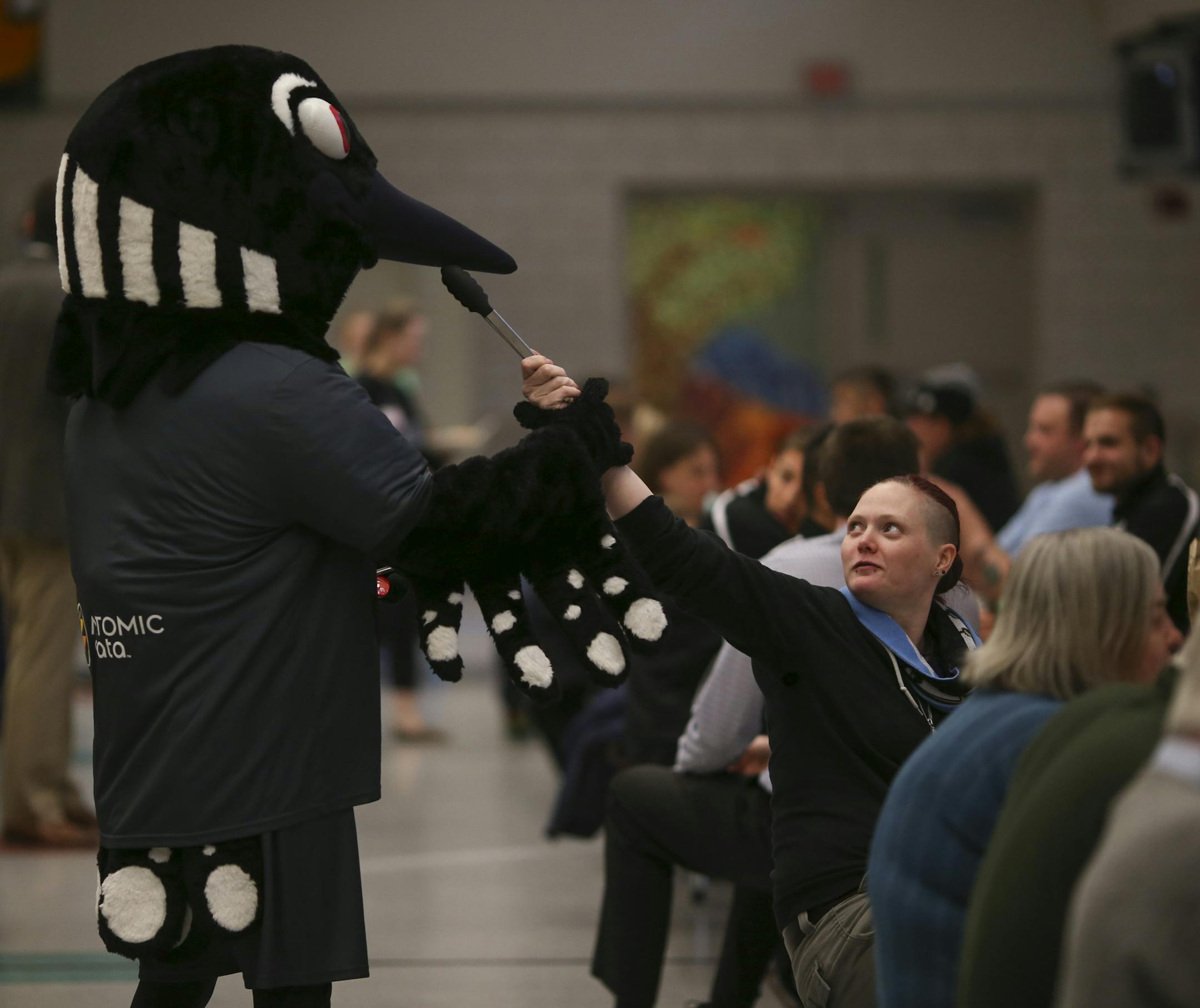 Season ticket holder Janelle Wilson teased P.K., the Minnesota United FC mascot during the potluck Tuesday night. ] JEFF WHEELER ï jeff.wheeler@startribune.com Minnesota United FC sponsored a potluck for their season ticket holders ahead of their home opener this weekend. The event was held Tuesday night, April 21, 2015 at Roseville High School.
