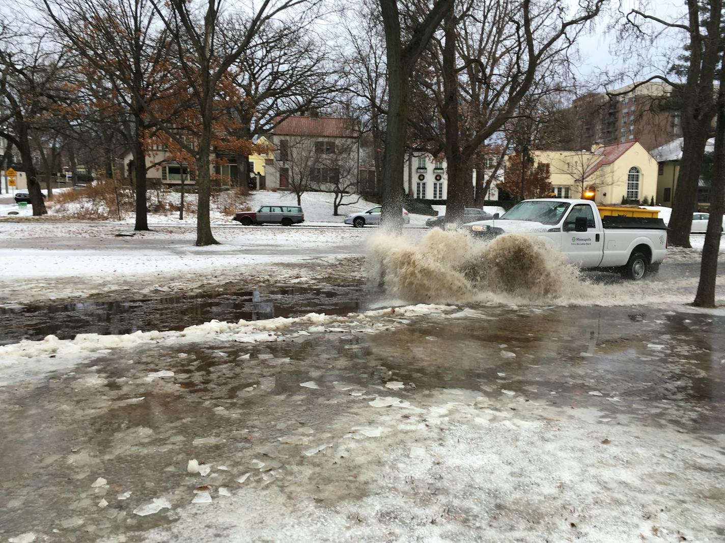 A truck tries to clear the bike path at Dean Parkway and 28th St. in south Minneapolis early Friday. Snow followed by rain on Thursday left slushy, slippery conditions around the Twin Cities on Friday.