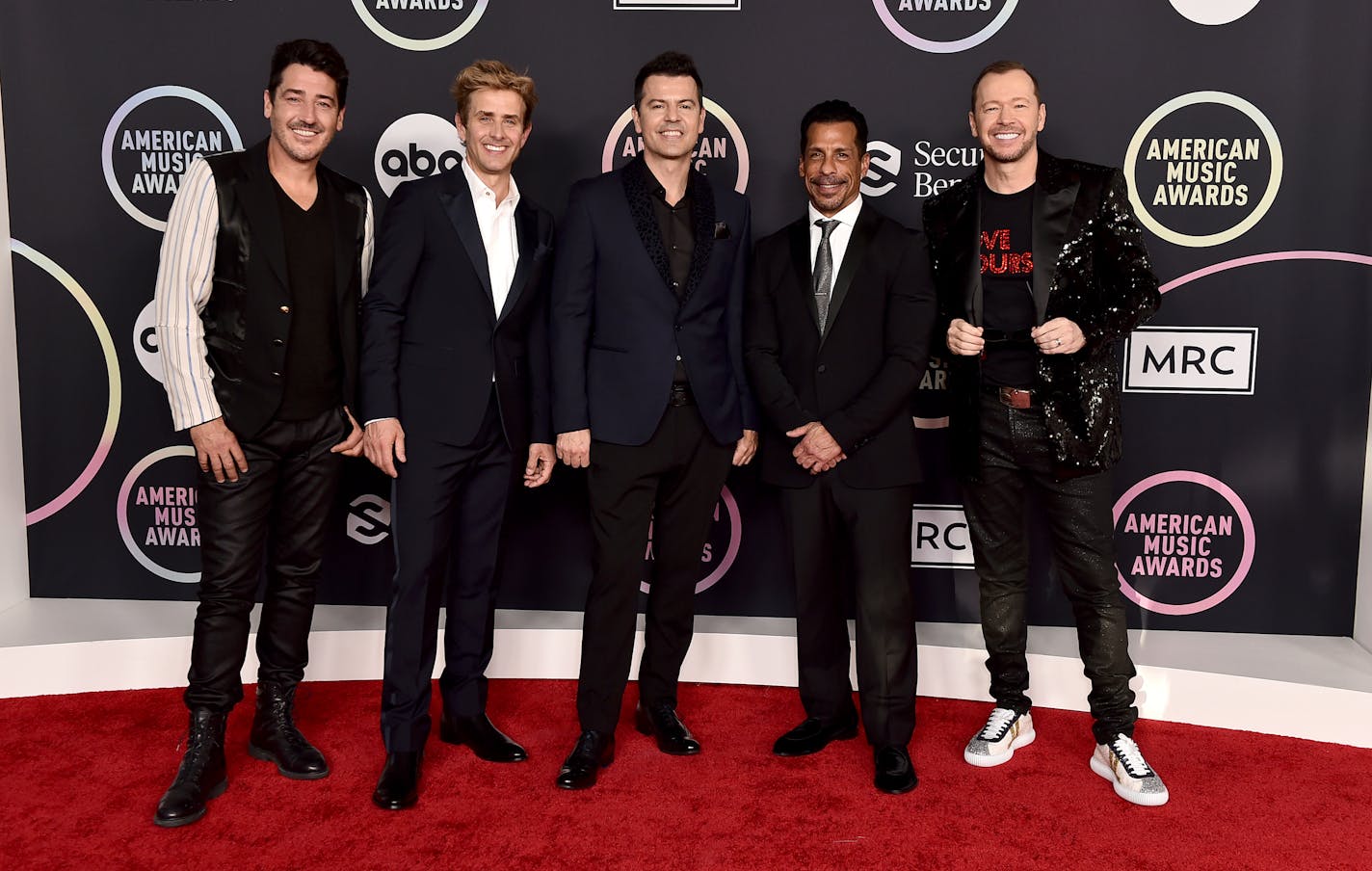 Jonathan Knight, from left, Joey McIntyre, Jordan Knight, Danny Wood and Donnie Wahlberg of New Kids On The Block arrive at the American Music Awards in 2021.