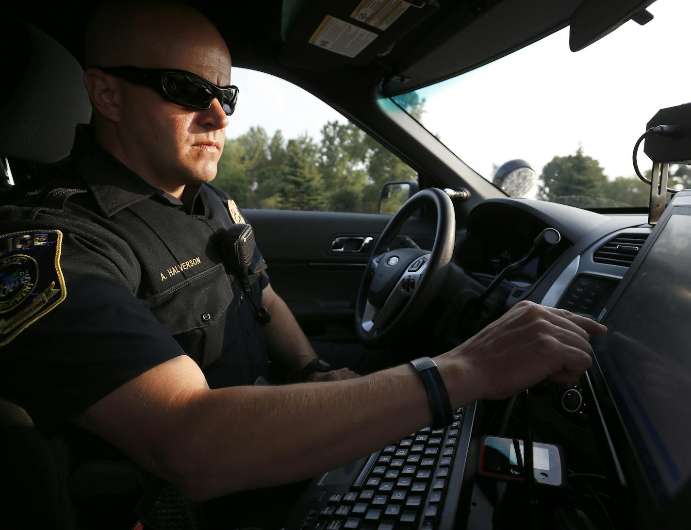 Lino Lakes police officer Adam Halverson checked a driver's information on the computer as he conducted a traffic stop on Monday. Officer Halverson has more than 500 stops in past two months. ] CARLOS GONZALEZ cgonzalez@startribune.com - August 31, 2015, Lino Lakes, MN, Adam Halverson is on his way to becoming the most well-known police officer in Lino Lakes. Lino Lakes new traffic cop who is making waves with more than 500 stop in his first two months.