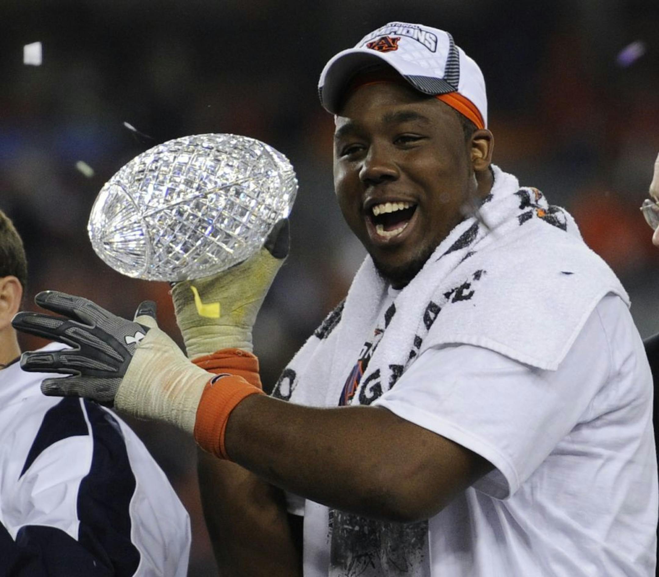 Auburn's Nick Fairley celebrates with the Coaches' Trophy after beating Oregon 22-19 in he BCS National Championship NCAA college football game Monday, Jan. 10, 2011, in Glendale, Ariz.