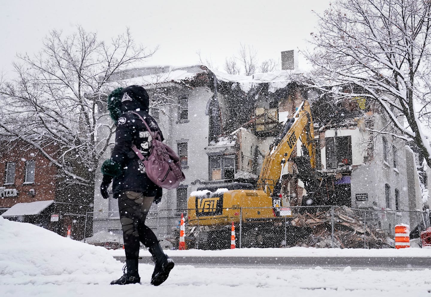 An apartment complex on the 2300 block of Lyndale Avenue South, destroyed by fire in early December, is demolished Wednesday, Jan. 4, 2023 in Minneapolis, Minn. The previously vacant apartment had been occupied by squatters at the time of the fire and one person escaped by jumping from a second story window. ]