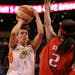 Phoenix Mercury guard Kelly Miller, left, shoots for two points over Houston Comets' Michelle Snow, during the second quarter of their WNBA basketball