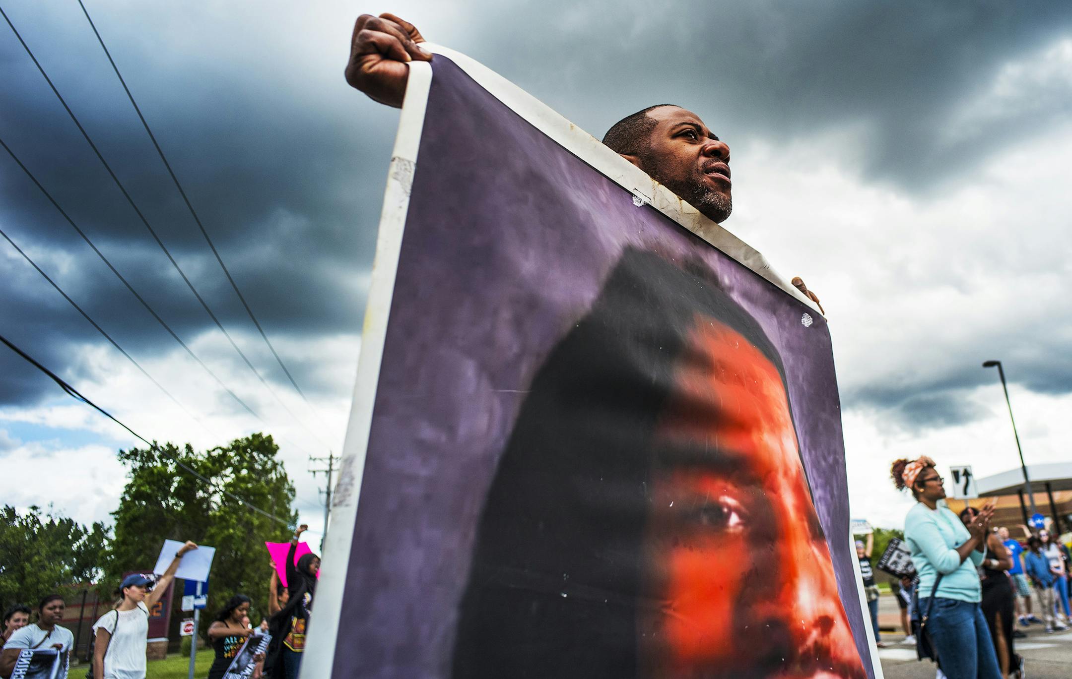 John Thompson, who said he was a close friend of Philando Castile, protests during a demonstration, Sunday, June 18, 2017, in St. Anthony, Minn. The protesters marched against the acquittal of Officer Jeronimo Yanez, was found not guilty of manslaughter for shooting Castile during a traffic stop. (Richard Tsong-Taatarii/Star Tribune via AP) ORG XMIT: MIN2017062014331821