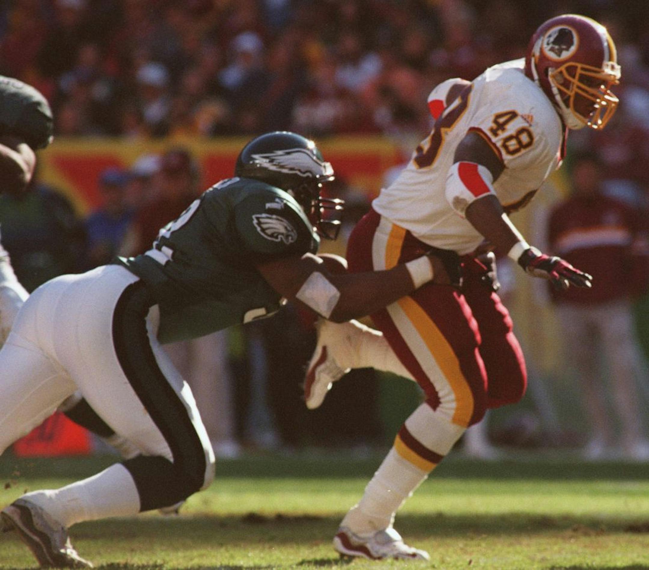 KRT SPORTS STORY SLUGGED: EAGLES-REDSKINS KRT PHOTOGRAPH BY STEVE DESLICH (KRT103) LANDOVER, MARYLAND November 28 - Washington Redskins running back Stephen Davis, #48, is tackled by Philadelphia Eagles defender Barry Gardner, #52, during Sunday's games. The Redskins beat the Eagles 20-17 in overtime. (KRT) PL,KD 1999 (Horiz)