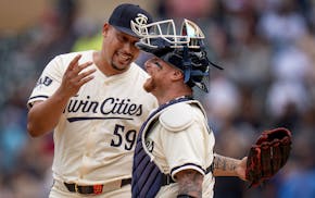 Twins closer Jhoan Duran (59) celebrates his save with catcher Christian Vázquez, whose home run in the fourth inning was key Sunday at Target Field.