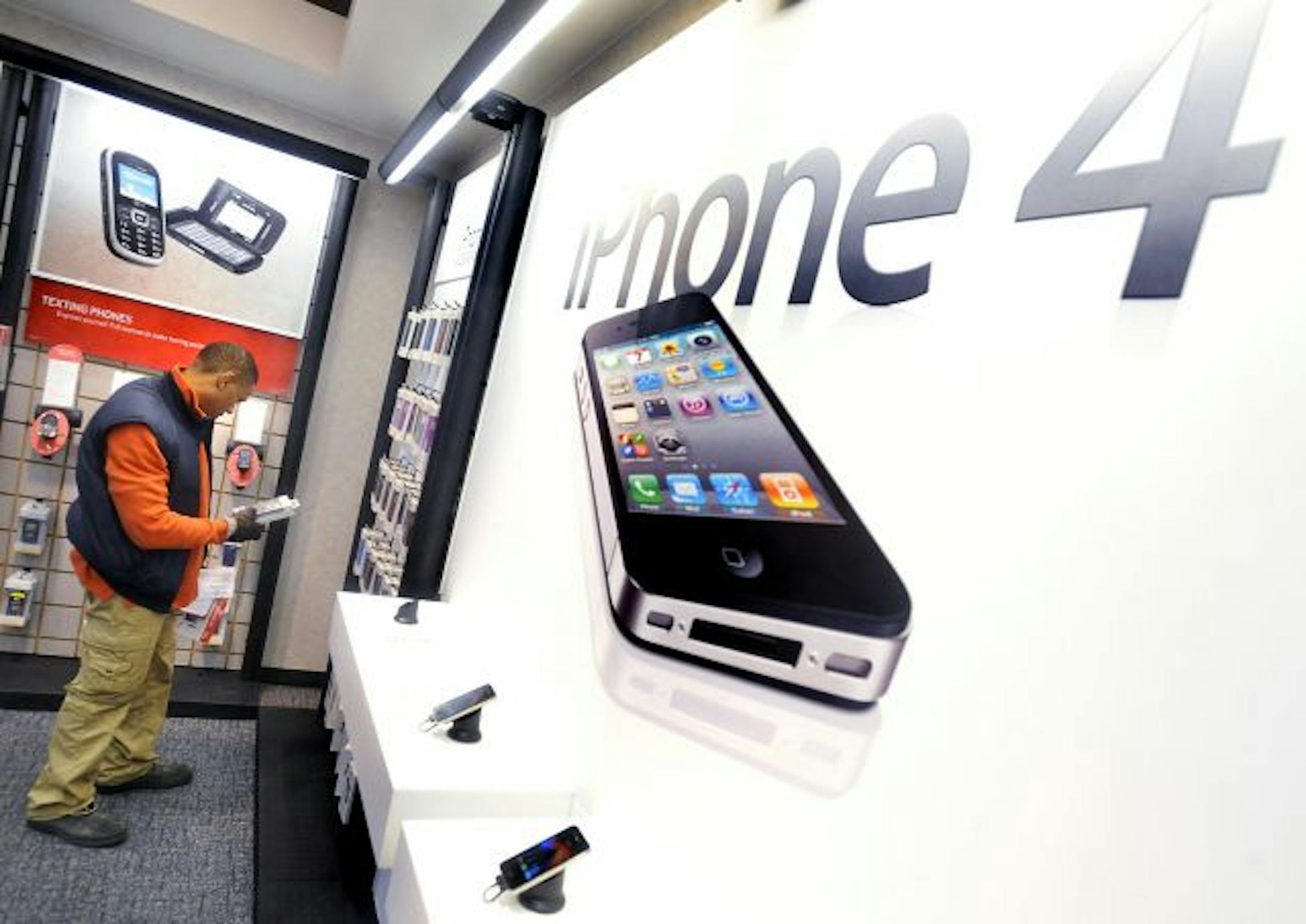 Kalvin Smith, who stood in line starting at 3:30 AM on the Verizon iPhone's first day of availability, picked out accessories for his new device at a Verizon store in Montgomery, Ala.