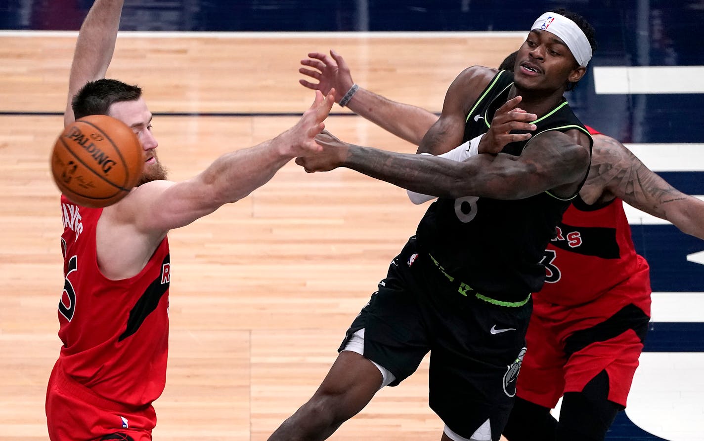 Minnesota Timberwolves forward Jarred Vanderbilt (8) passed the ball as Toronto Raptors center Aron Baynes (46), left, and Toronto Raptors guard Fred VanVleet (23) defended during the second quarter. ] LEILA NAVIDI • leila.navidi@startribune.com