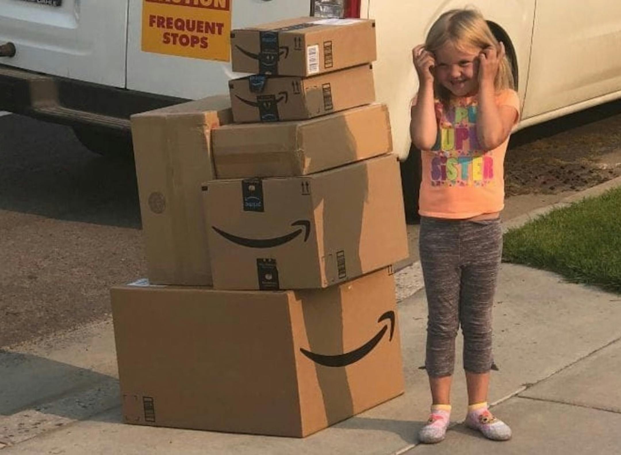 Katelyn Lunt, 6, stands by the packages of Barbies she ordered after they are delivered to her Utah home. MUST CREDIT: Photo courtesy of John Diyalou ORG XMIT: MIN1808231019060711
