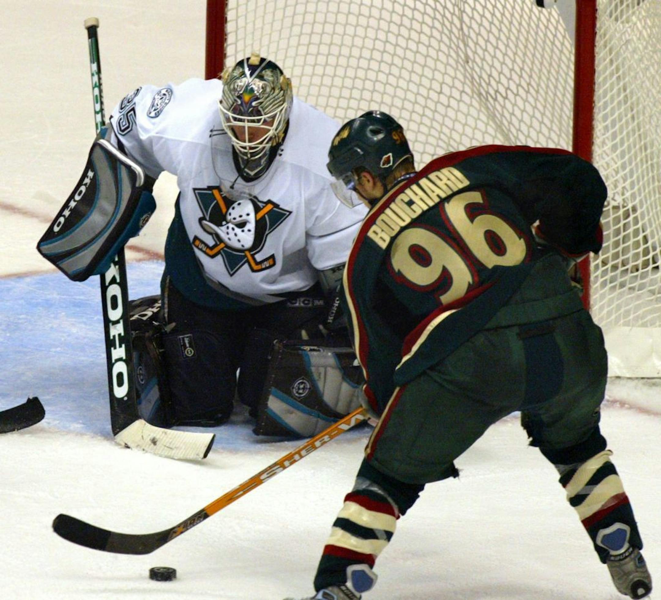 The Ducks J. Giguere makes yet another save on a shot-on-goal by the Wild's Pierre-Marc Bouchard in third period action.
