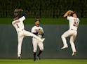 The Twins outfielders celebrated the win with almost simultaneous jump shots after an MLB baseball game.