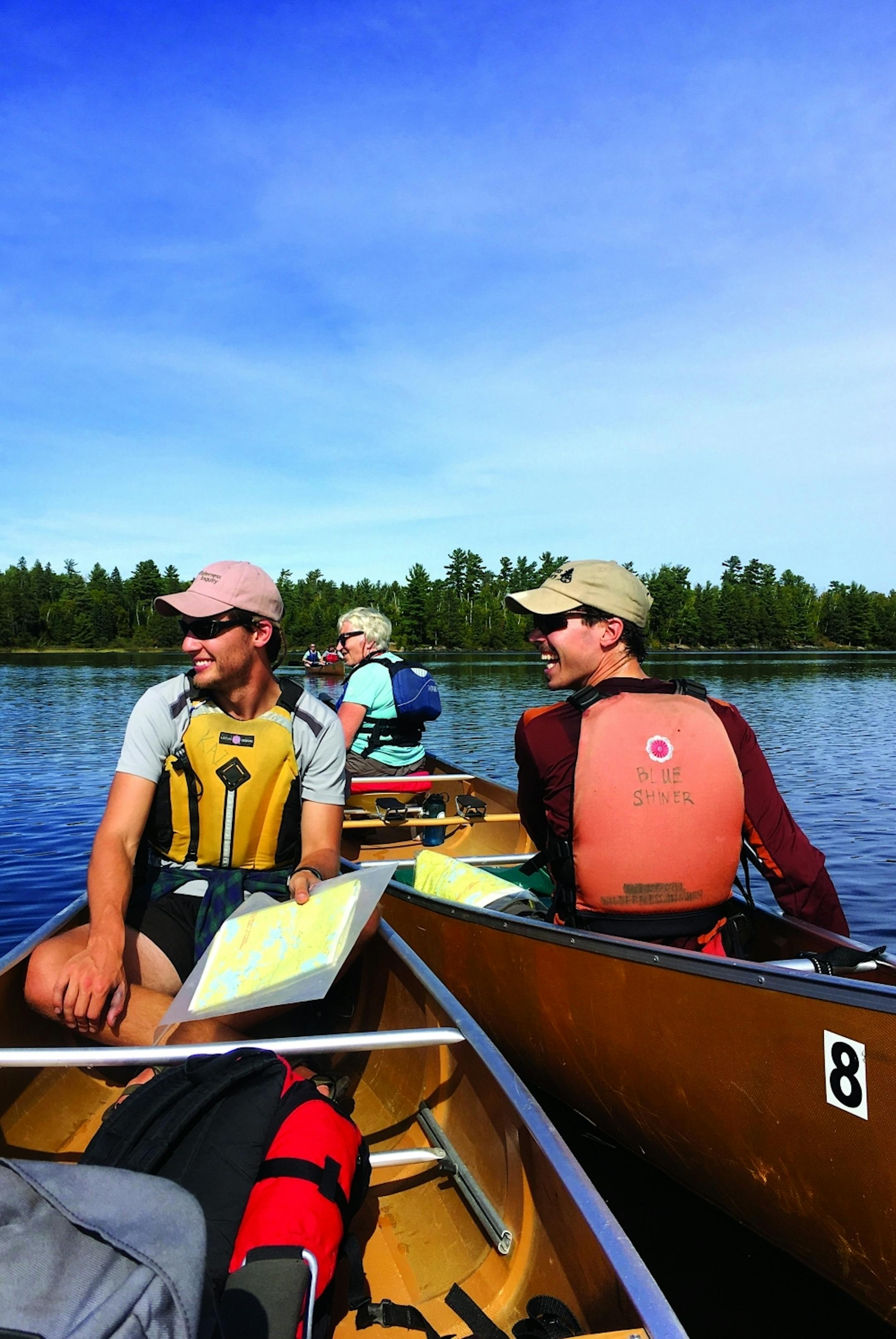 Wilderness Inquiry guides Kai Ashland (left) and Devan Landseidel pulled their canoes close to check the map. Photo by Jenna Ross * jenna.ross@startribune.com