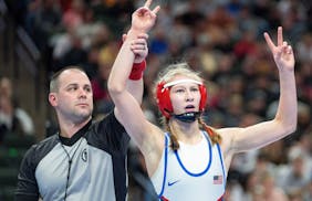 Simley wrestler Charli Raymond celebrates after defeating Fridley wrestler Olivia Sackor during the MSHSL wrestling state tournament championships Sat