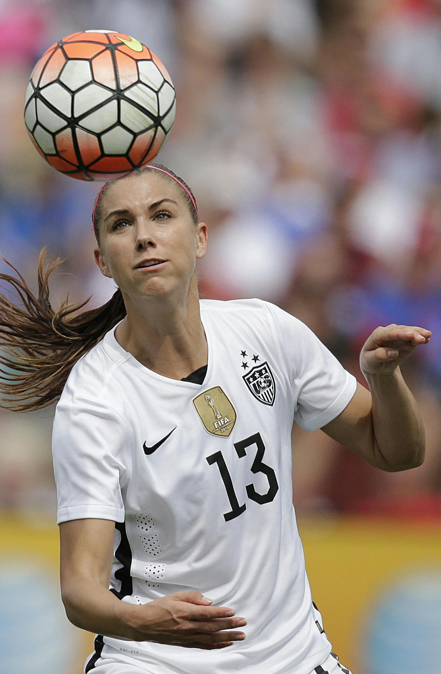 United States' Alex Morgan heads the ball agasint Haiti during the U.S. Women's World Cup victory tour, Sunday, Sept. 20, 2015, in Birmingham, Ala. (AP Photo/Brynn Anderson)