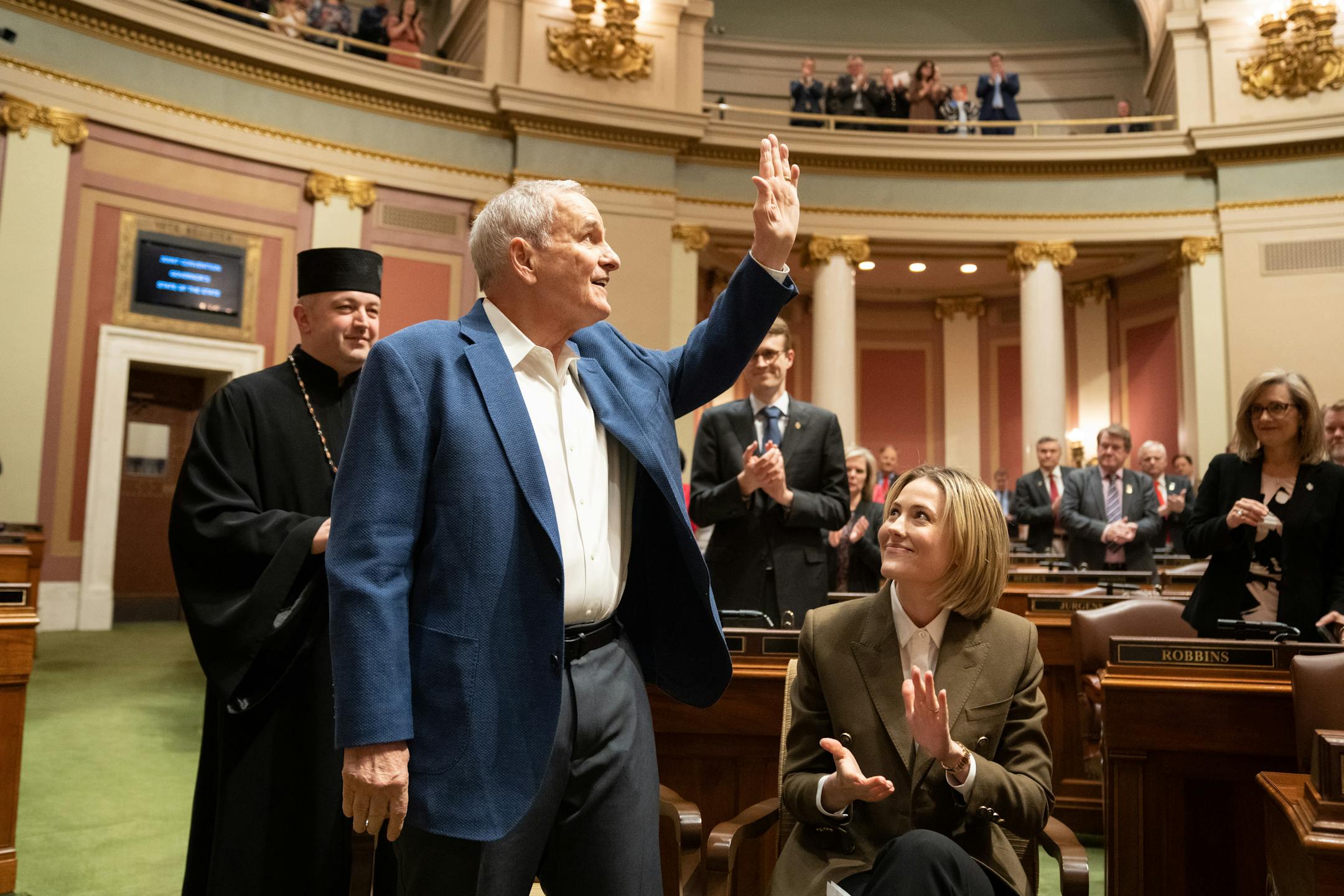 Former Minnesota Gov. Mark Dayton stood to a round of applause as he and his wife Ana Dayton attended the State of the State address.