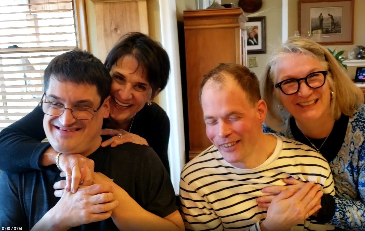 Pat Leseman and Rosemary Fagrelius sit side-by-side hugging their sons, Mike and John.