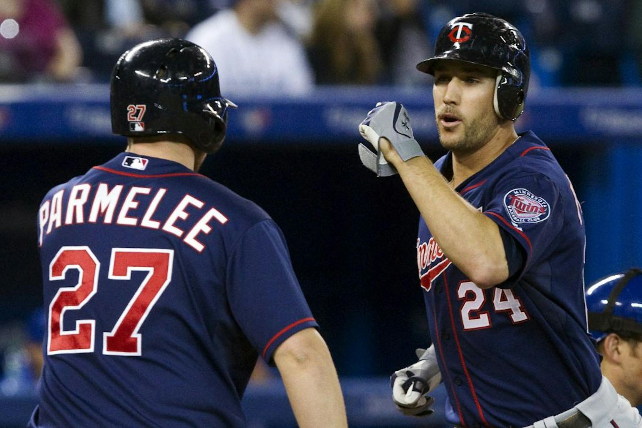The Twins' Trevor Plouffe, right, celebrated with Chris Parmelee after hitting a two-run home run against the Toronto Blue Jays during the second inning Monday.