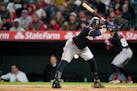 The Twins' Carlos Santana dodges an errant pitch during the eighth inning Friday in Los Angeles. Santana's poise at the plate was responsible for two 