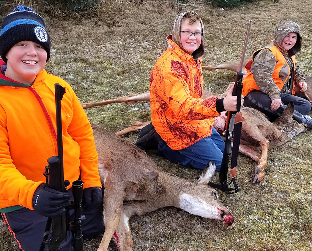 All three boys shot antlerless deer within an hour of each other on the afternoon of Saturday, Nov. 18, about 20 miles south of Superior, Wisc. From left to right they are Gavin Lagro, 12; Kale Flemming, 11, both of Shakopee; and Henry Lagro, 11, of Bloomington.