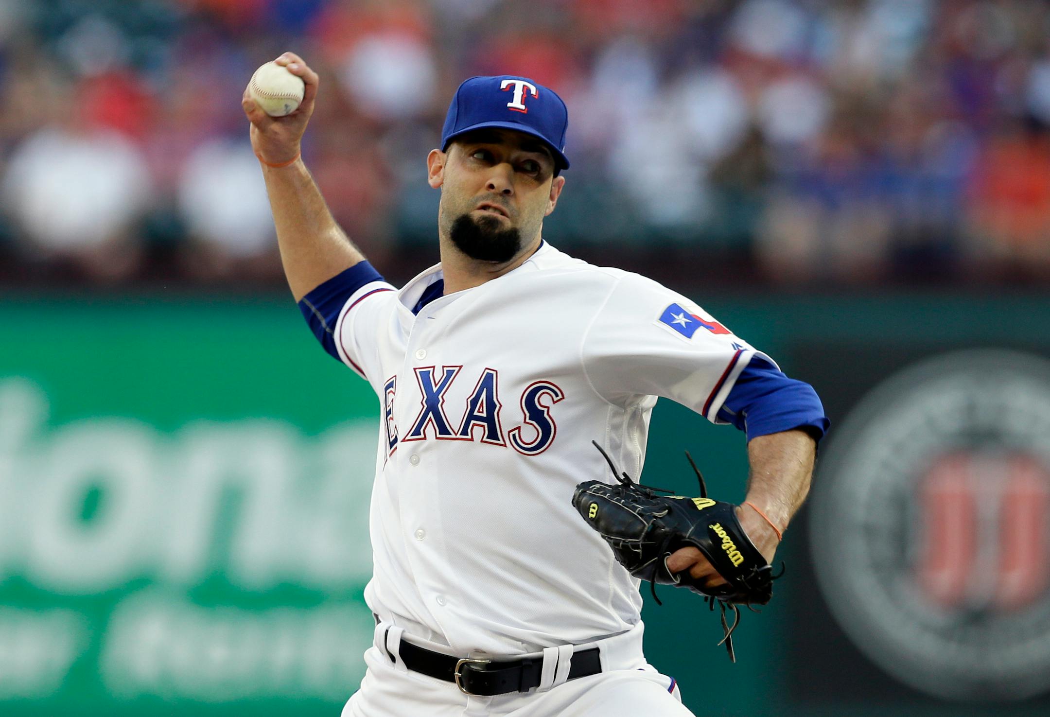 FILE - In this June 6, 2017, file photo, Texas Rangers starting pitcher Dillon Gee throws against the New York Mets in the first inning of an interleague baseball game, in Arlington, Texas. The Minnesota Twins have added two reinforcements for their depleted pitching staff, right-handers Dillon Gee and Trevor Hildenberger. (AP Photo/Tony Gutierrez, File)