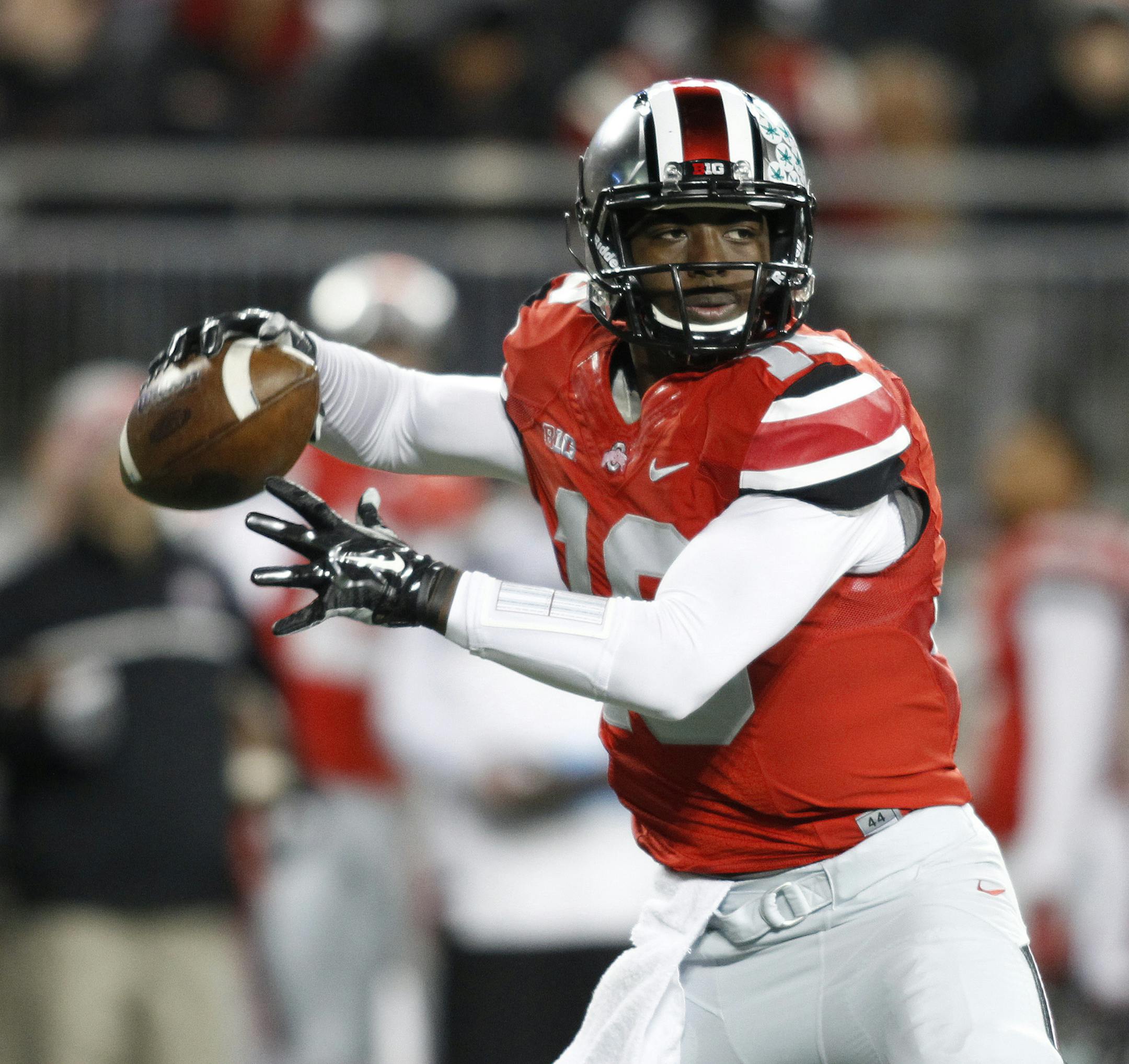 Ohio State quarterback J.T. Barrett drops back to pass against Illinois during the first quarter of an NCAA college football game Saturday, Nov. 1, 2014, in Columbus, Ohio. (AP Photo/Paul Vernon) ORG XMIT: OHJL109