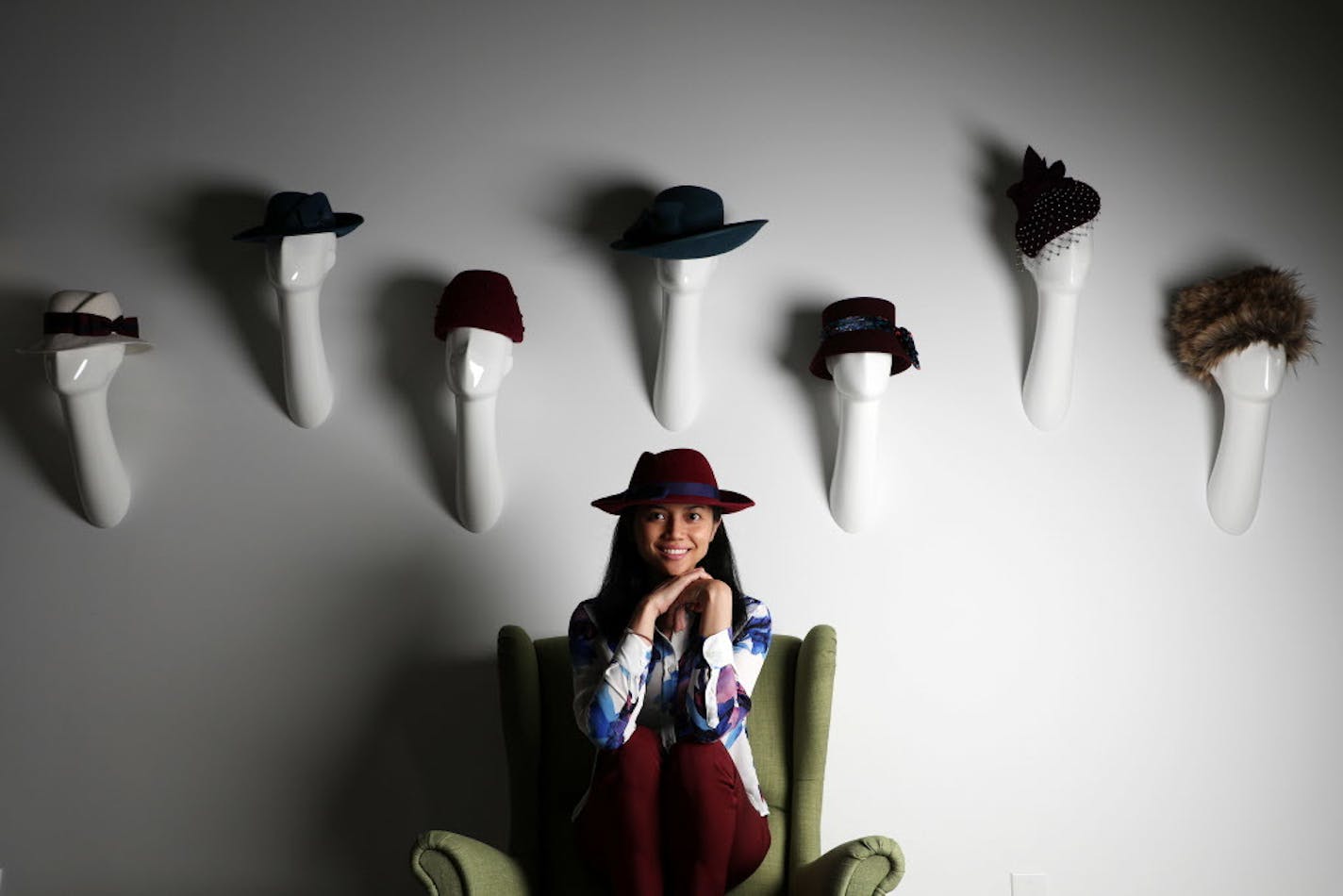 Local hat maker Karen Morris Millinery sat a portrait in her studio along with hats from her fall collection.