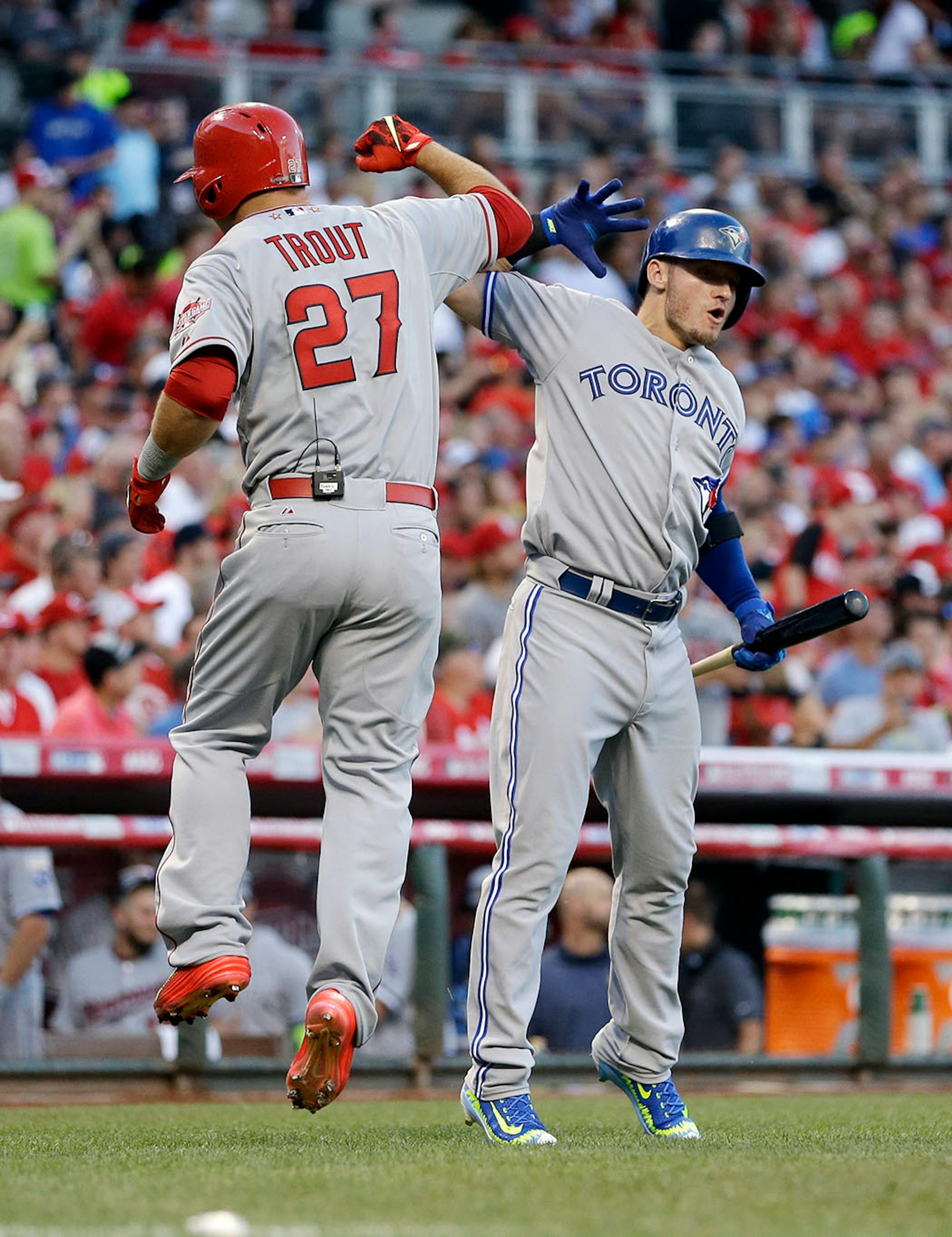 American League's Mike Trout, of the Los Angeles Angels, celebrates with American League's Josh Donaldson, of the Toronto Blue Jays, after Trout hit a lead off home run during the first inning of the MLB All-Star baseball game, Tuesday, July 14, 2015, in Cincinnati.