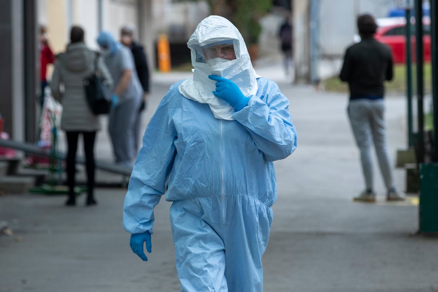 A health worker wore a protective suit at the infectious disease clinic in Zagreb, Croatia, where the first coronavirus case in Croatia is hospitalized, Tuesday, Feb. 25, 2020. Croatia confirmed its first case of coronavirus in a man who had been to Milan, the capital of Lombardy, Italy. (AP Photo/Darko Bandic)