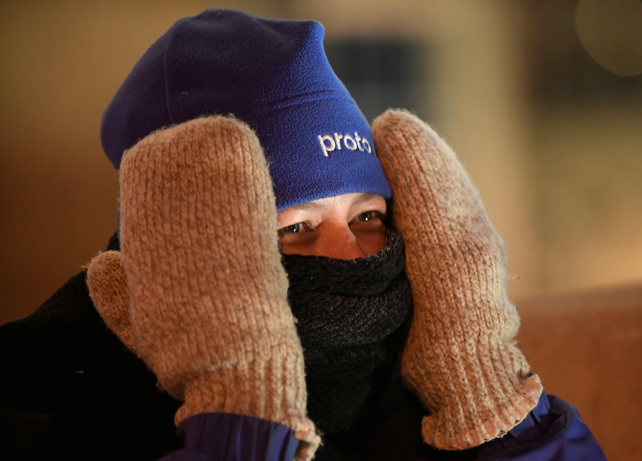 Lisa Samuelson, of Minneapolis, had a hard time keeping her hands and face warm as she waited for the Grain Belt sign to be relit Saturday night.