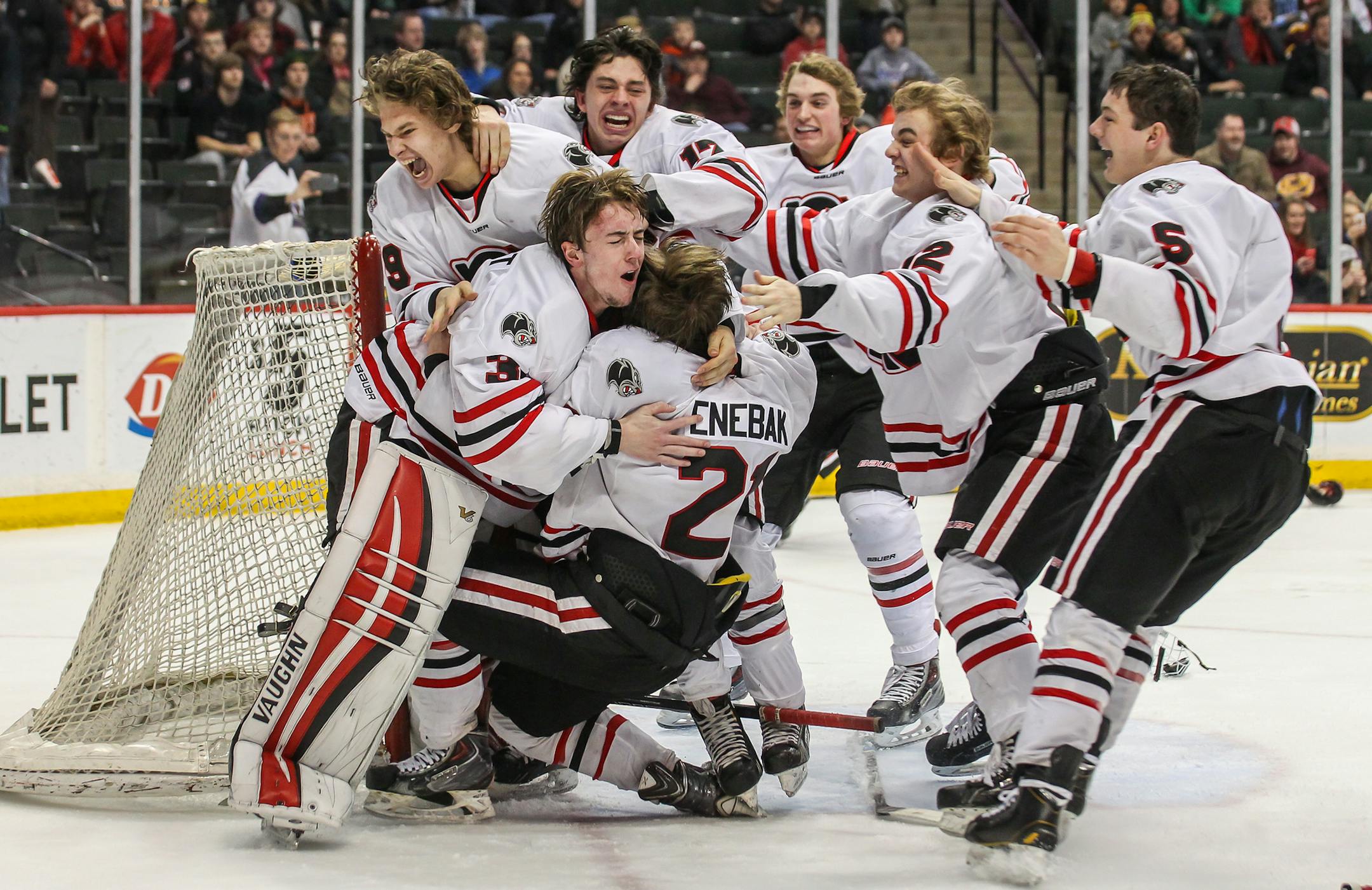 Lakeville North players including Henry Enebak mob goaltender Ryan Edquist in celebration of a 4-1 victory over Duluth East in the 2015 Class 2A state boys hockey championship game on March 7 at Xcel Energy Center in St. Paul. Photo by Mark Hvidsten