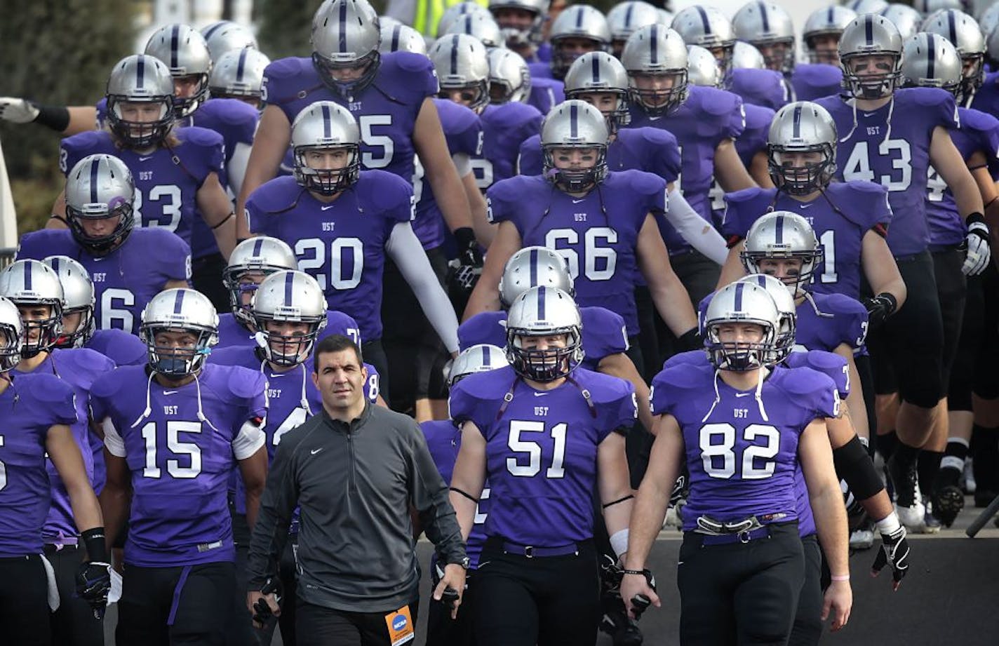 UST head football coach Glenn Caruso led his team on to the field.