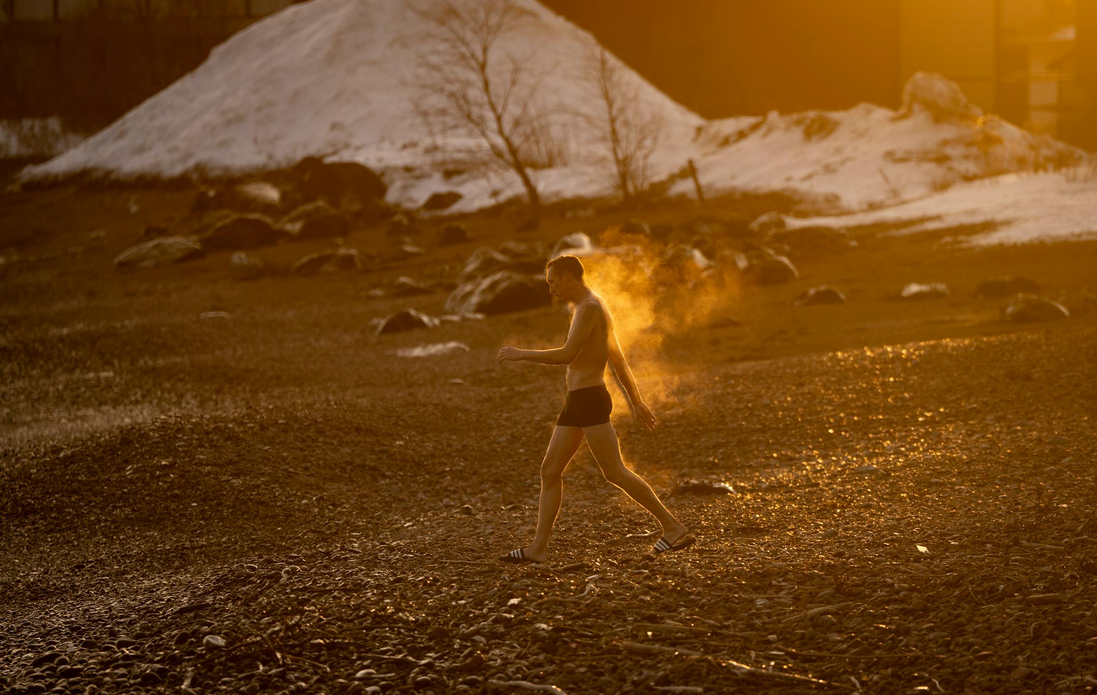 Shaun Tudor has steam coming off his body as he takes a walk to Lake Superior after sitting in a hot sauna at Sisu and Löyly Sauna.