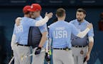 United States team members celebrate winning a men's curling match against Britain at the 2018 Winter Olympics in Gangneung, South Korea, Wednesday, F