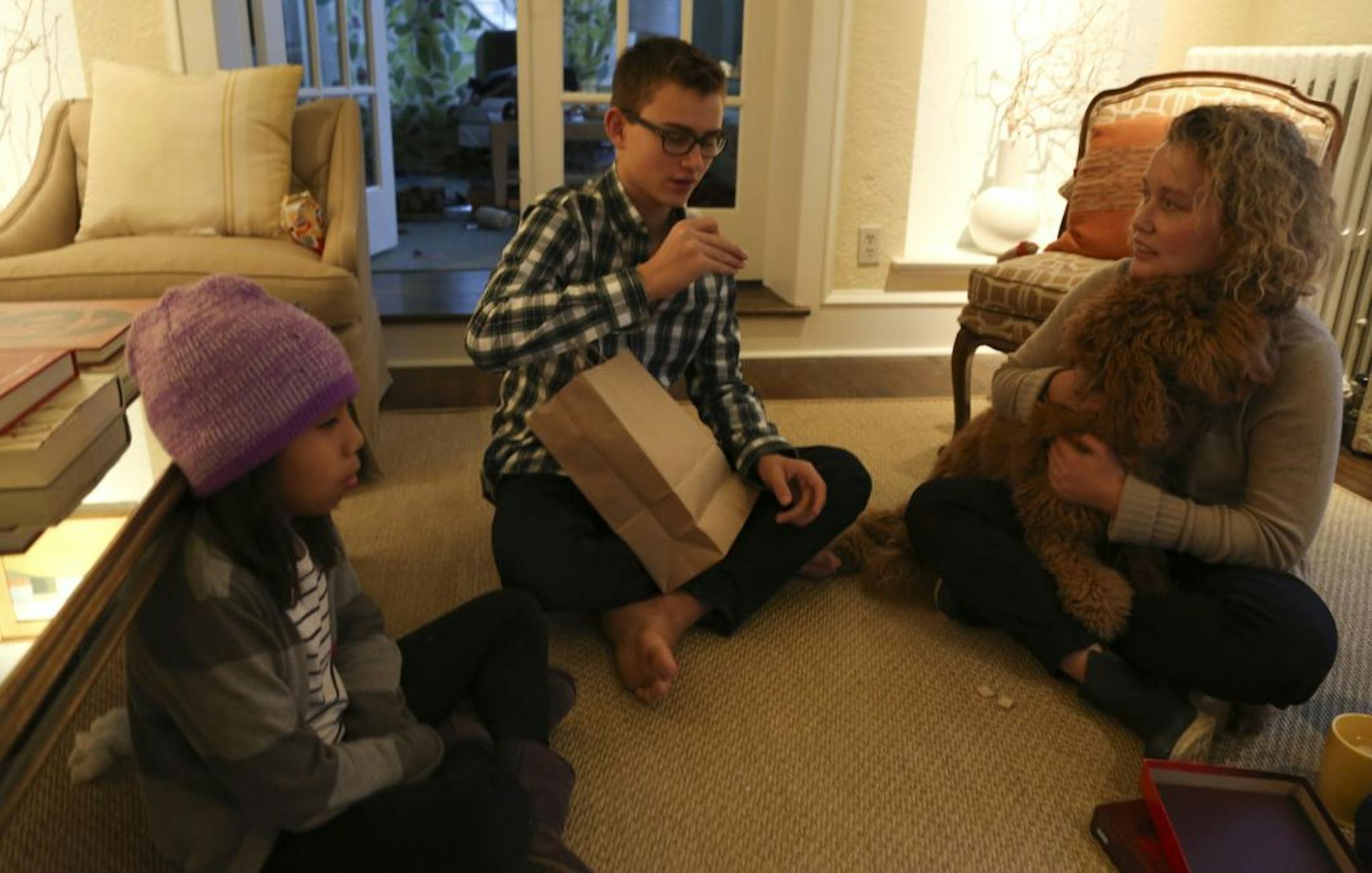Luisa Schleisman, 8; Peter Schleisman, 13, and mom Elizabeth Foy Larsen played a game at their home in Minneapolis.