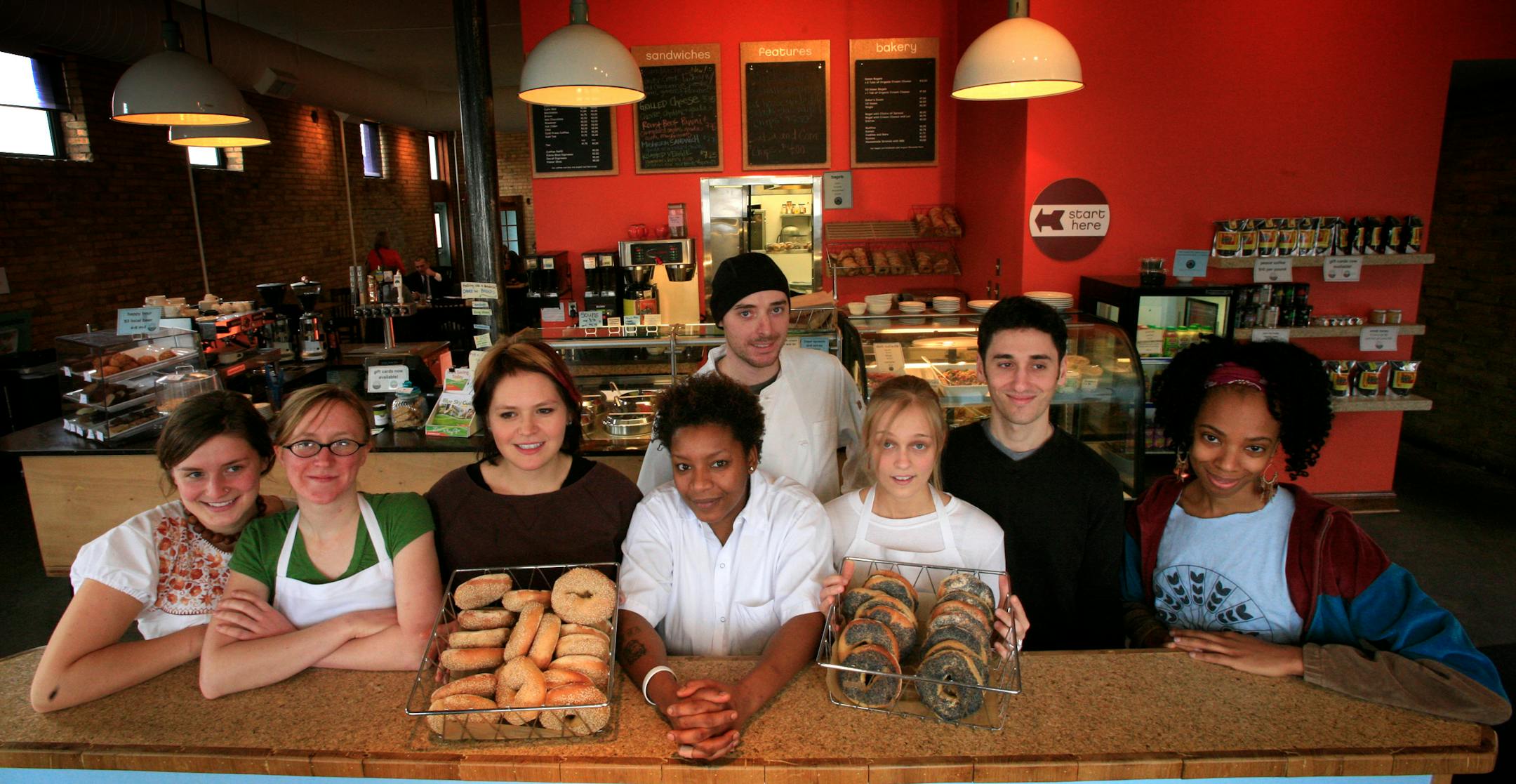 It takes a crew to keep the busy Common Roots Cafe from left to right: Alisa Hoven, barista; Ixchel Swinehard, cook; Maria Benavides, barista; Kotiareenia Taylor, cook; Tanya Peterson, baker; Danny Schwartzman, owner; Monique Askew, community organizer; and in the back Phil Werst, general manager.