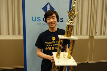 Andrew Tang with his trophy for winning a share of the National High School Chess Championship.