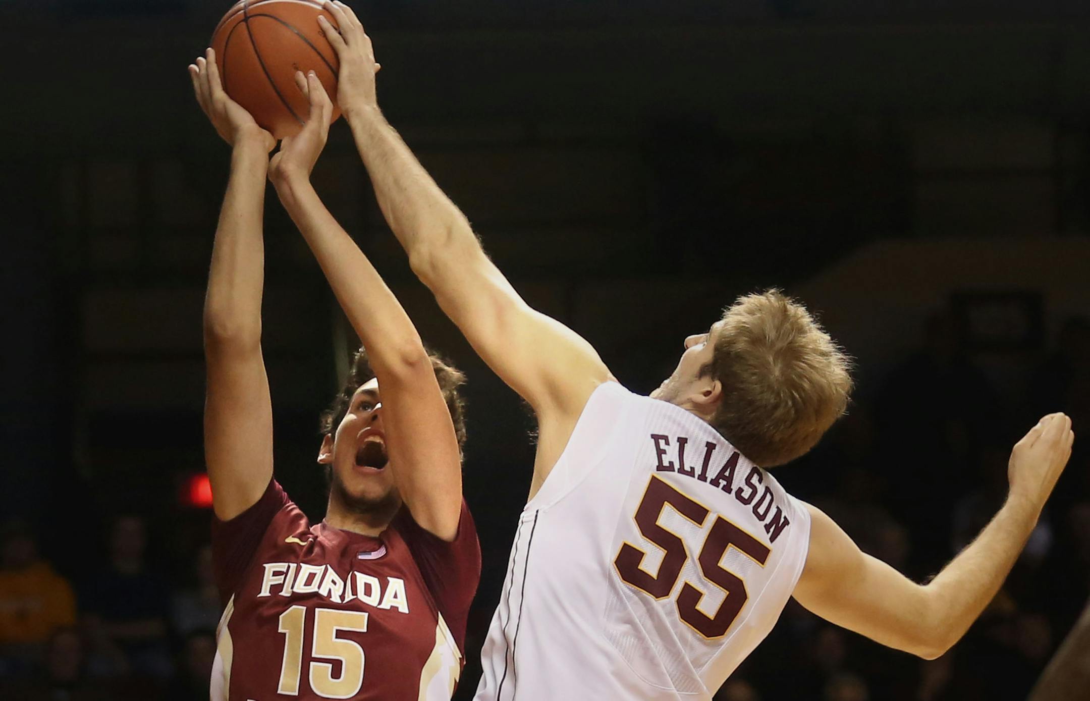 Gopjers Elliott Eliason blocked the shot of Florida State's Boris Bojanovsky during the first half at Williams Arena in Minneapolis, Tuesday, December 3, 2013.
