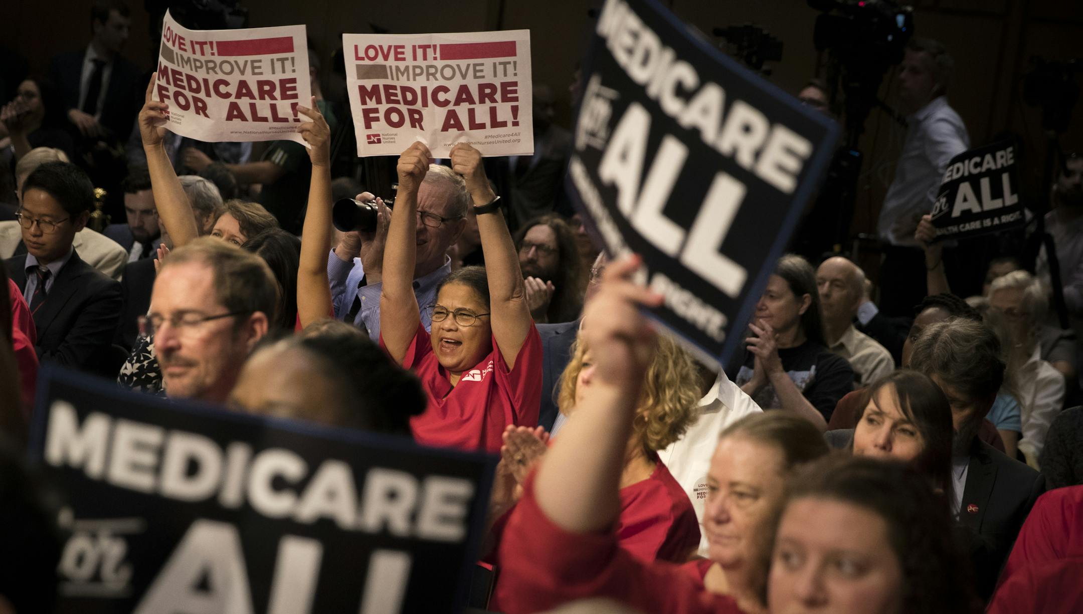FILE — Nurses hold up signs supporting Medicare for All proposals at a rally on Capitol Hill in Washington, Sept. 13, 2017. The question of whether to support a single-payer health care model has been one of the thorniest dilemmas for several Democrats considering a 2020 presidential campaign. (Tom Brenner/The New York Times)