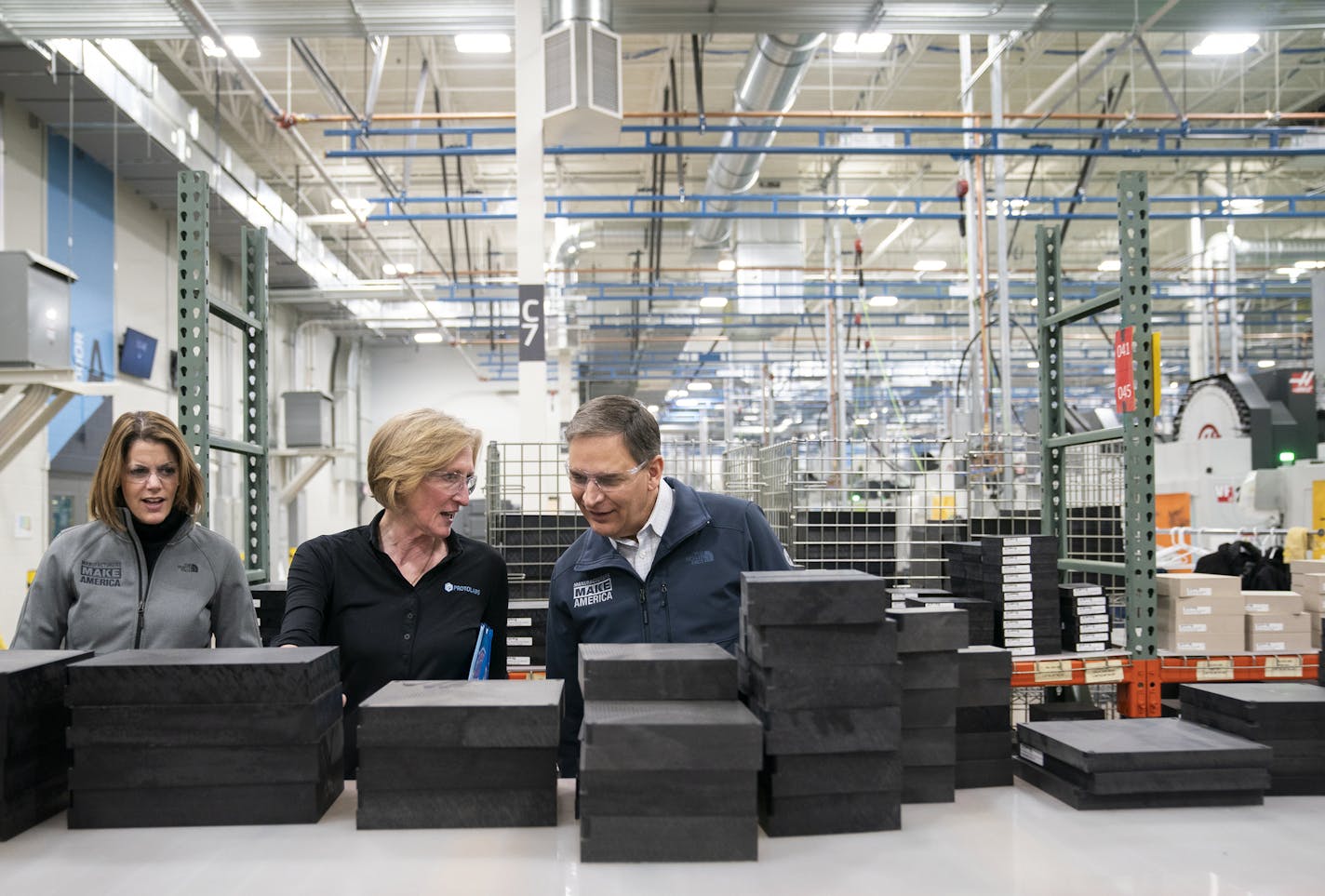 Carolyn Lee, from left, executive director of the Manufacturing Institute, tours the Protolabs manufacturing facility with Protolabs president and CEO Vicki Holt, and Jay Timmons, president and CEO of the National Association of Manufacturers.