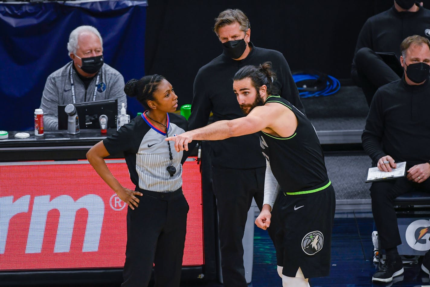 Minnesota Timberwolves guard Ricky Rubio, right, argues with referee Danielle Scott as Timberwolves coach Chris Finch looks on during the second half of an NBA basketball game against the Dallas Mavericks on Wednesday, March 24, 2021, in Minneapolis. (AP Photo/Craig Lassig)