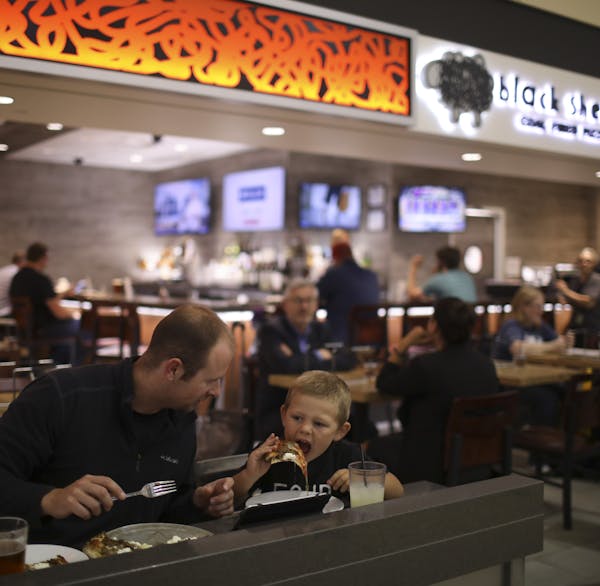 Adam Fike and his son, Connor, ate at Black Sheep Coal Fired Pizza in the MSP Mall in the Lindbergh Terminal. ] JEFF WHEELER &#xef; jeff.wheeler@start