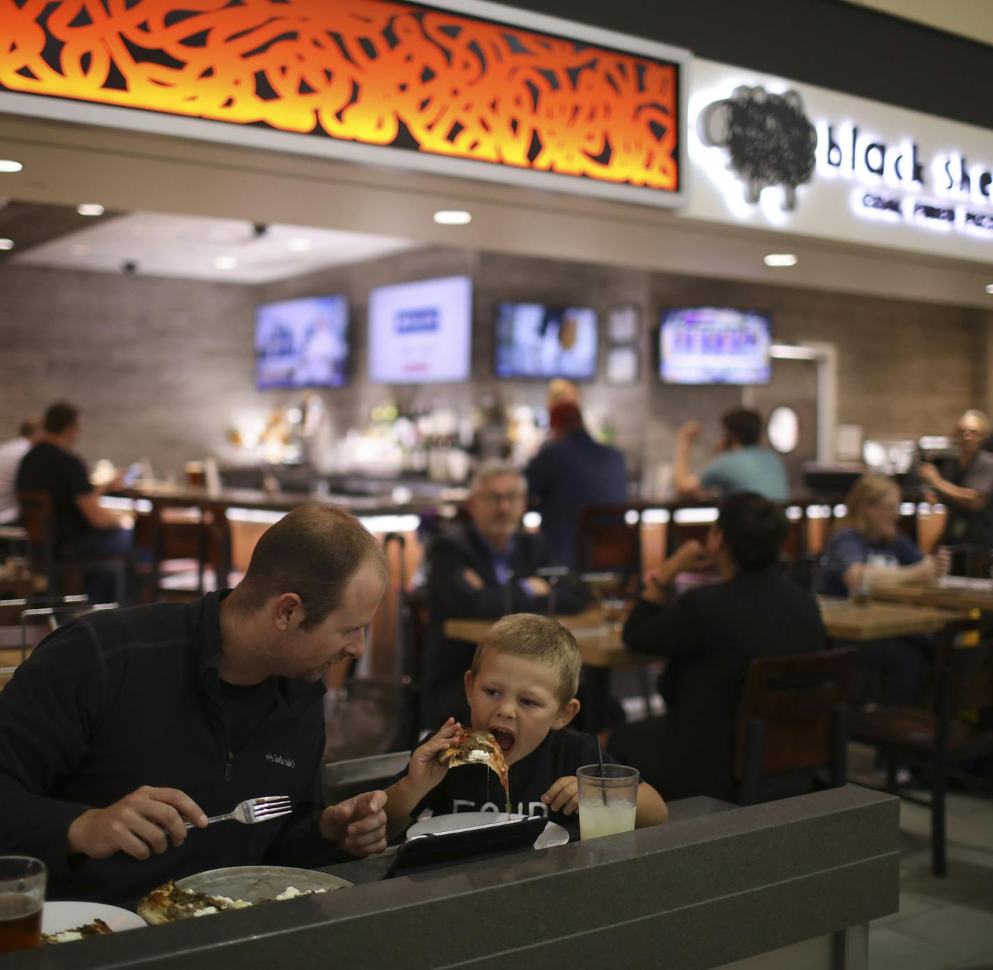 Adam Fike and his son, Connor, ate at Black Sheep Coal Fired Pizza in the MSP Mall in the Lindbergh Terminal. ] JEFF WHEELER &#xef; jeff.wheeler@startribune.com The MSP airport is home to loads of new shops and restaurants that are the result of the current refresh of the Lindbergh Terminal. Several were photographed Tuesday afternoon, August 22, 2017 in Minneapolis.