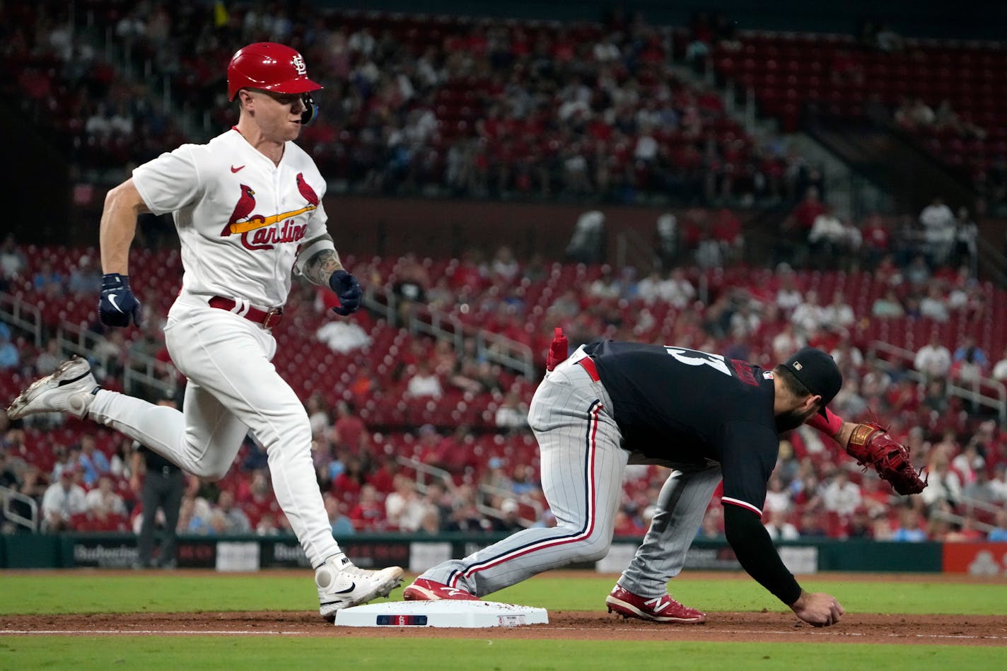 St. Louis Cardinals' Tyler O'Neill, left, grounds out as Minnesota Twins first baseman Joey Gallo handles the throw during the fifth inning of a baseball game Wednesday, Aug. 2, 2023, in St. Louis. (AP Photo/Jeff Roberson)