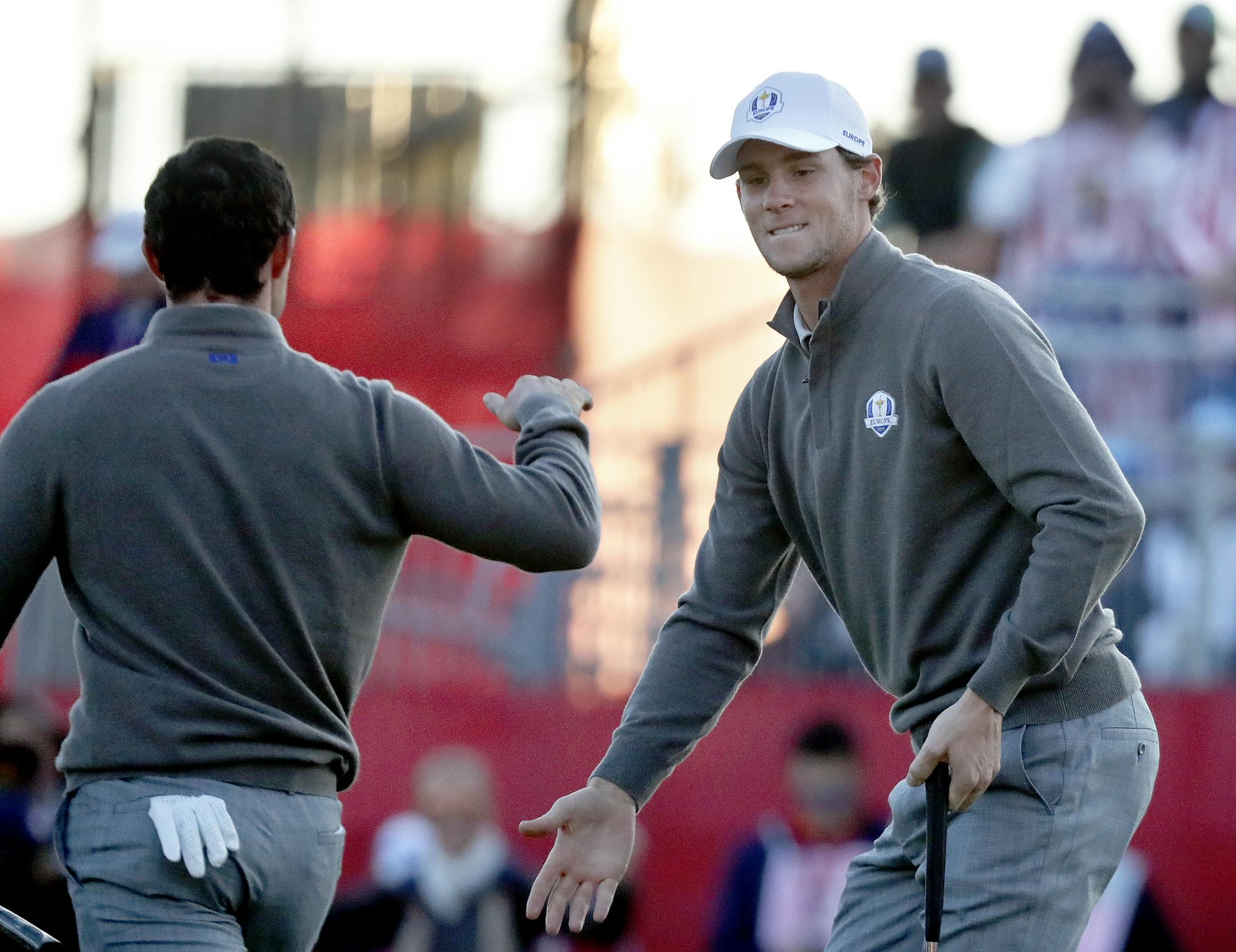 Rory McIlroy celebrated with Thomas Pieters after he drained a 18 footer on the first tee to start foursome pairings and matchups Saturday morning. ] CARLOS GONZALEZ cgonzalez@startribune.com - The Ryder Cup morning play Saturday October 1, 2016 at Hazeltine National Golf Club in Chaska, Minn.
