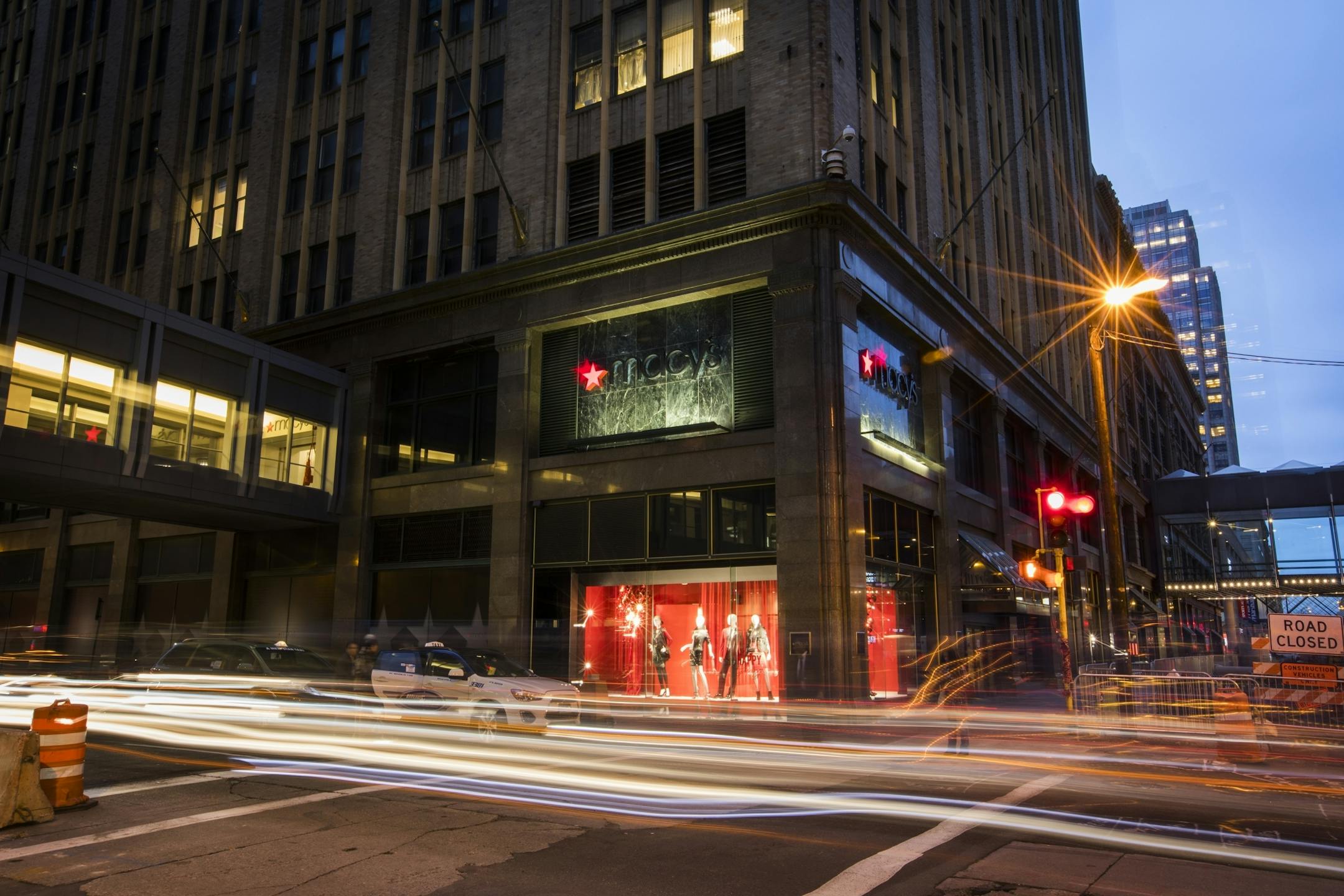 Cars drive past Macy's on S. 8th Street and Nicollet Mall in downtown Minneapolis.