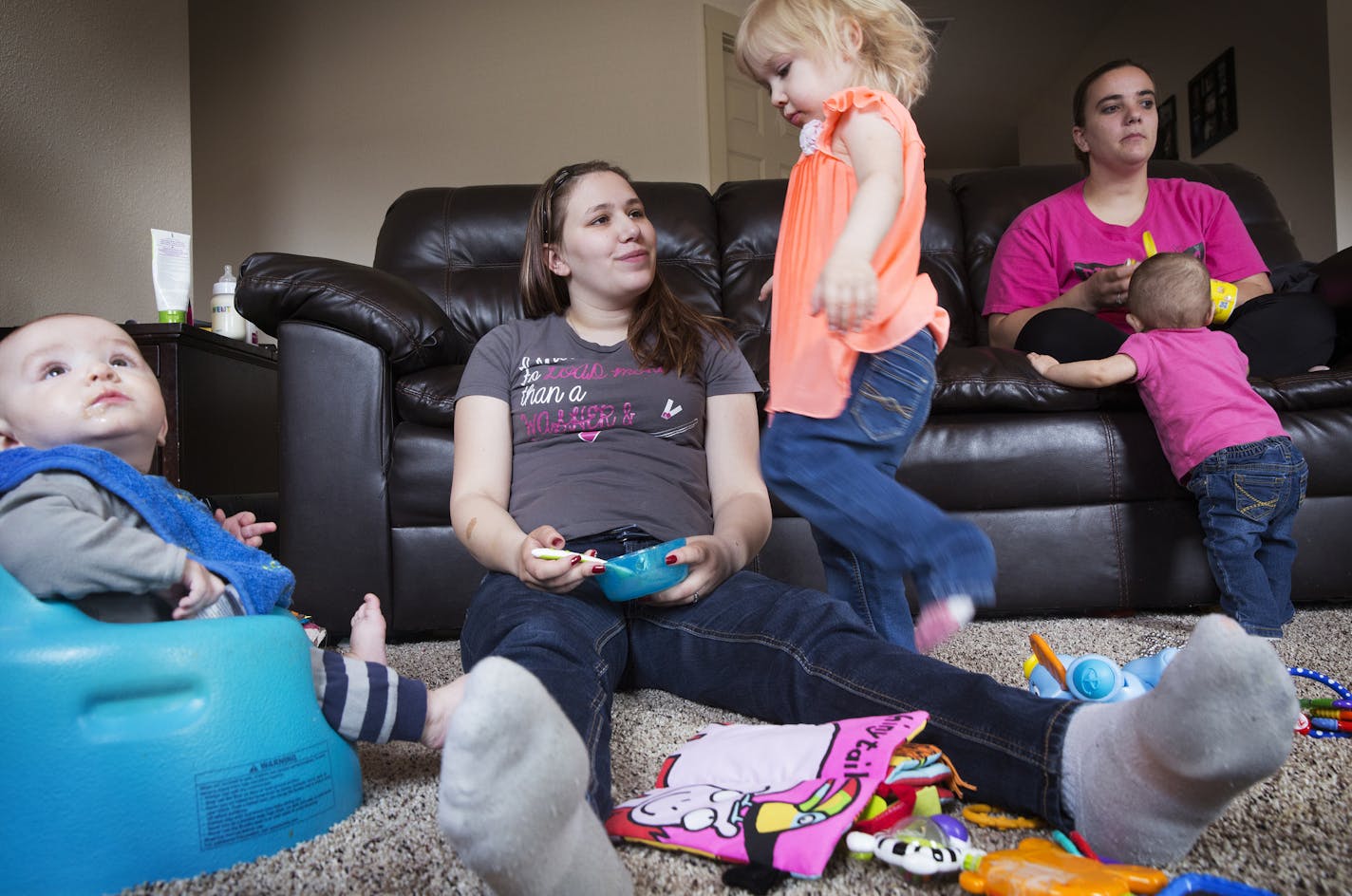 Kendra Hill, left, and Shaleena Layton, right, both members of the Oilfield Wives of Williston, hang out together at Hill's home with Hill's six-month-old son Donny, from left, daughter Hannah, 2, and Layton's nine-month-old daughter Katie on Thursday, April 2, 2015. ] LEILA NAVIDI leila.navidi@startribune.com /