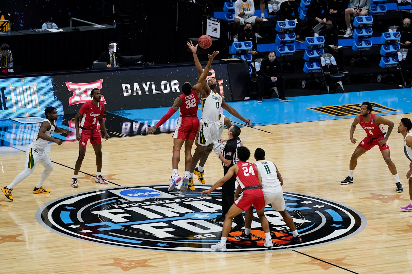 Houston forward Reggie Chaney (32) fights for the opening tipoff with Baylor forward Flo Thamba (0) Saturday